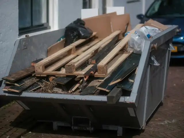 Skip loaded with old timber, pallets and scrap wood